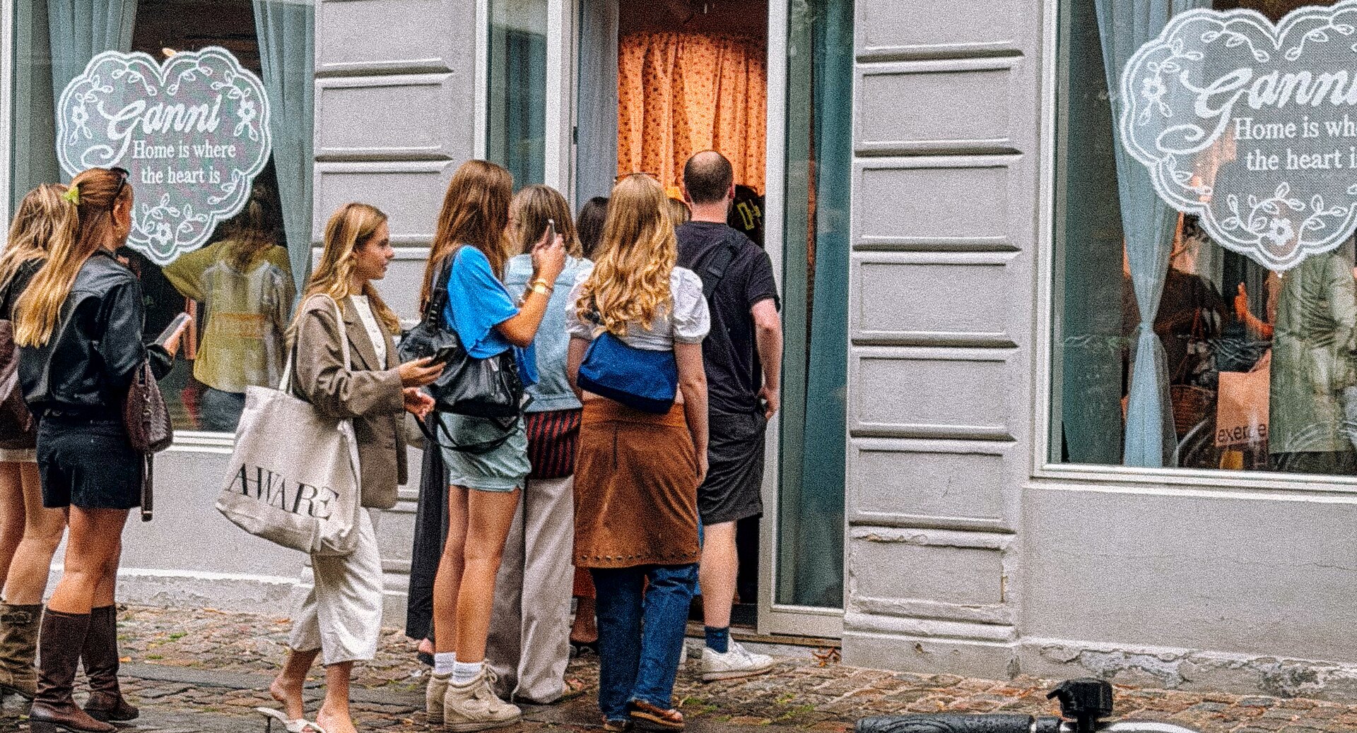 A crowd gathered outside a Copenhagen storefront during fashion week